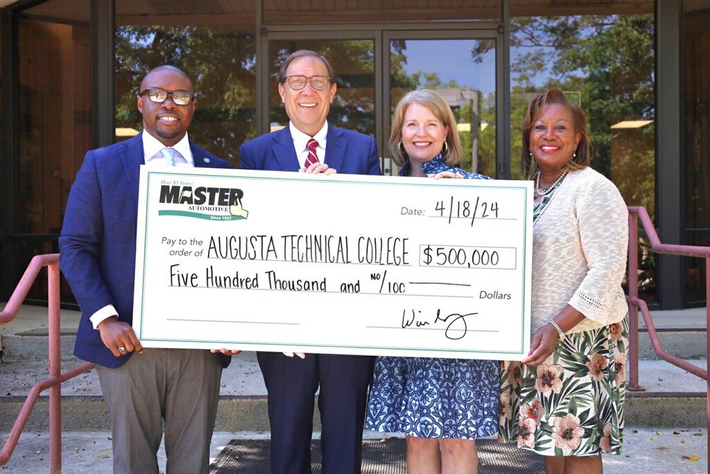 Dr. Jermaine Whirl, President of Augusta Technical College stands with Will Schafer, CEO of Master Automotive and his wife Kathy Schafer, and Shelia Stuberfield,  the Augusta Technical College Foundation Treasurer holding a check for $500,000.