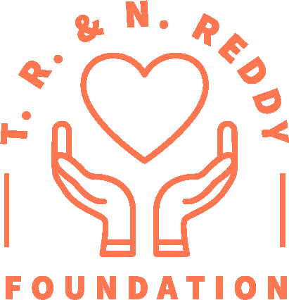 The T.R. & N. Reddy Foundation logo in orange composed of two hands with the wrists facing inwards and the fingers pointing up to create a bowl shape around a heart shaped outline. The text T.R. & N. Reddy form an arch above the heart with two vertical lines at the beginning an end separating the text from the word Foundation which forms the base of the logo.