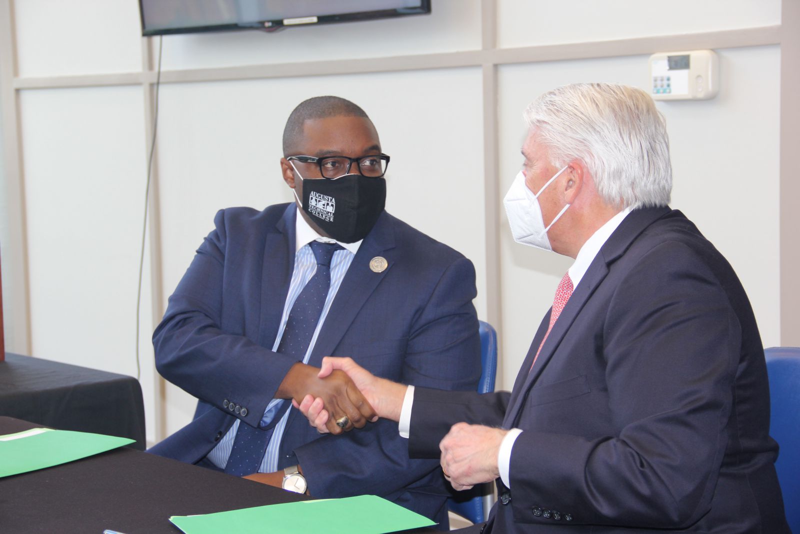 President of Augusta Technical College, Dr. Jermaine Whirl, shakes hands with University Health Care System Chief Executive Officer, James R. Davis.
