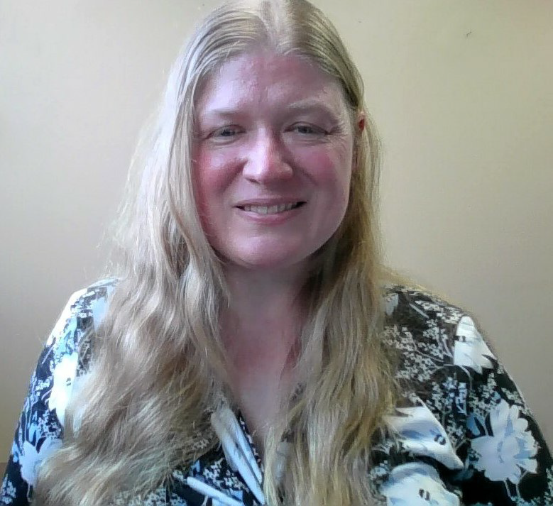 Ms. Sarah Osborn, a Caucasian female with long blonde hair, smiles at the camera wearing a black and white floral shirt, pictured against a tan background.